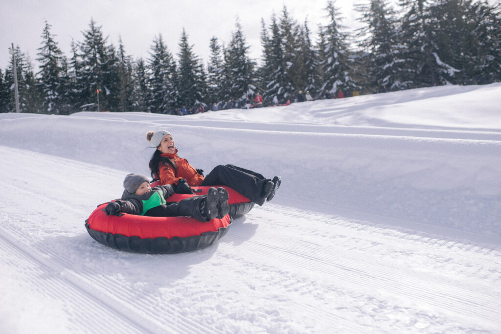 parent and child enjoying tubing at Whistler Blackcomb Tube Park